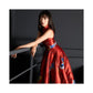 Model leaning on railing wearing a red brocade jacquard cheongsam dress.