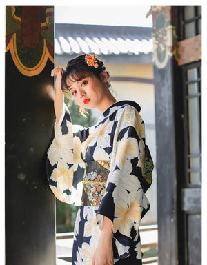 Japanese kimono dress with a floral design, styled with a decorative obi belt, perfect for festivals and traditional occasions.