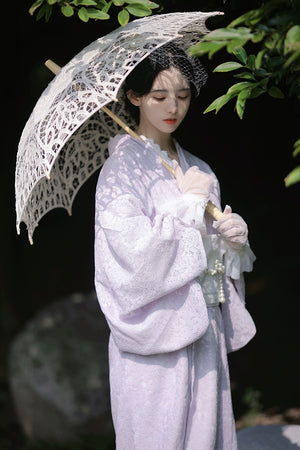 Purple lace kimono styled with a lace parasol in a serene setting.