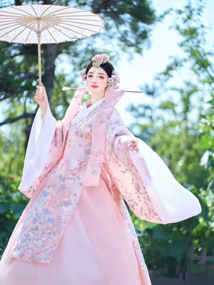 Elegant pink Korean court dress with floral patterns, styled with a parasol.