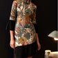 Front view of cheongsam dress with floral jacquard and velvet details.