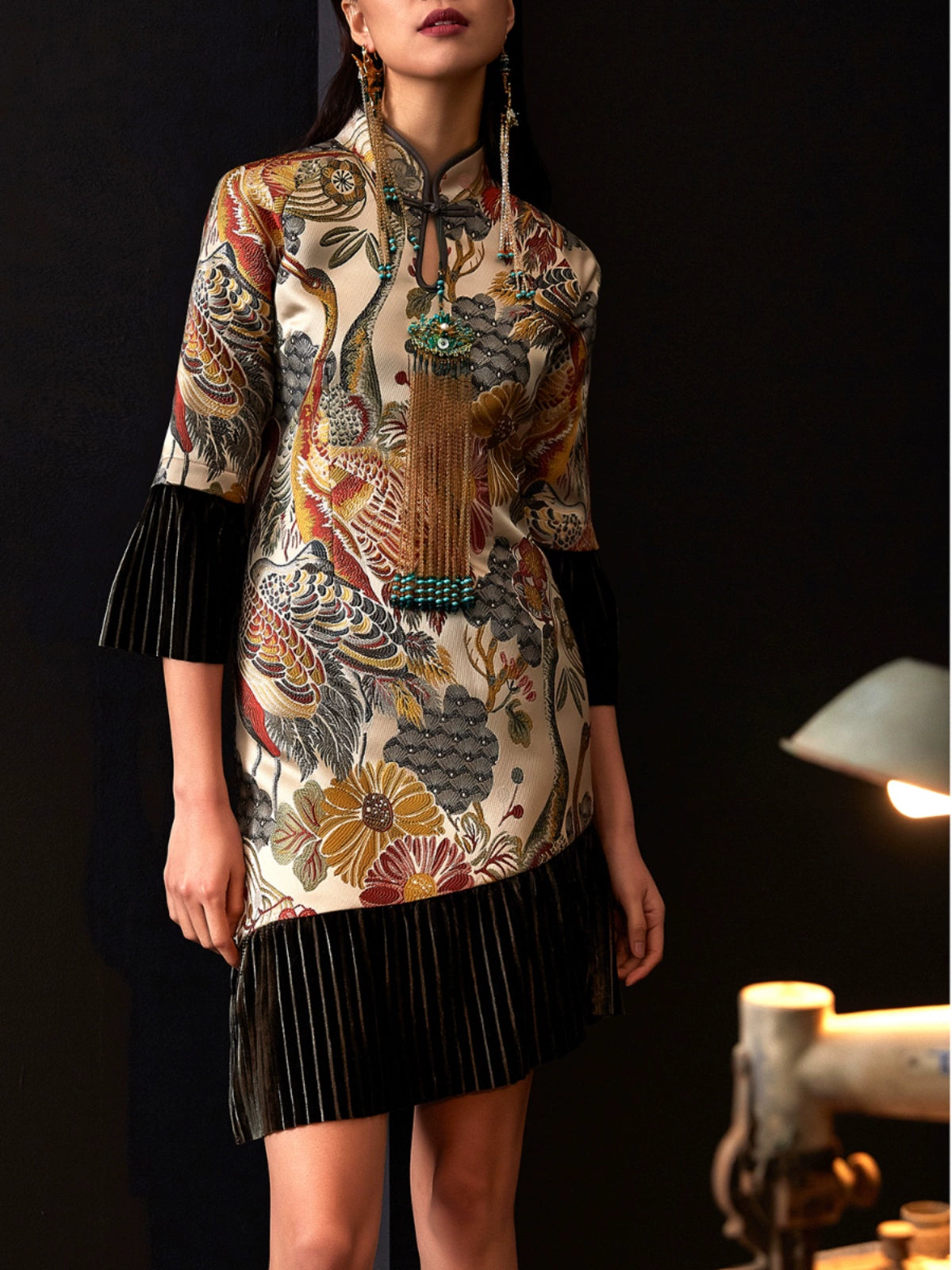 Front view of cheongsam dress with floral jacquard and velvet details.