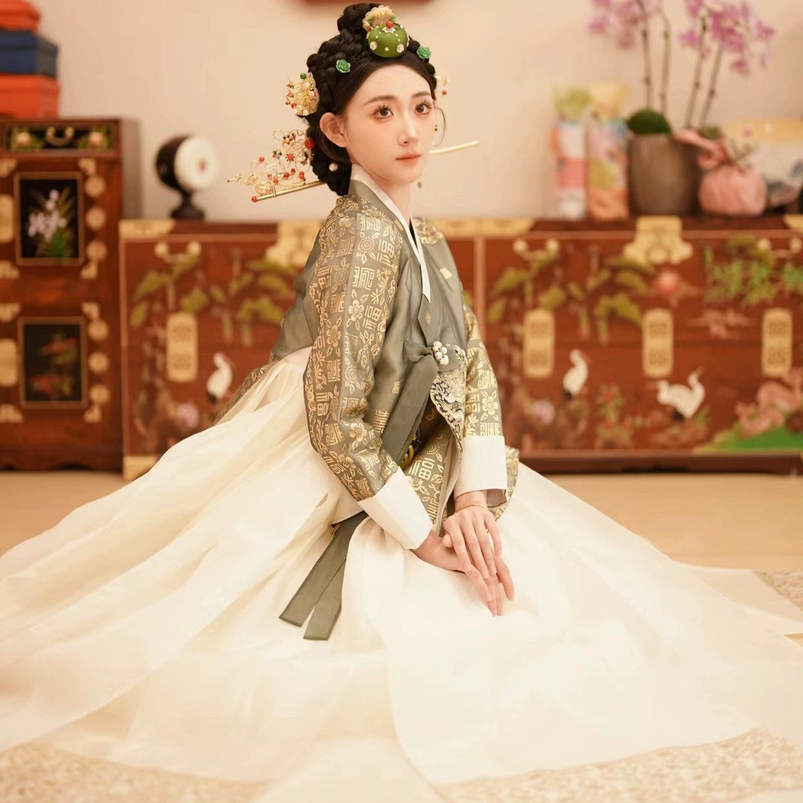 Seated pose of Korea Princess Hanbok with intricate gold patterns.