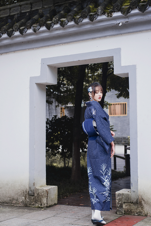 Side profile of blue Japanese kimono yukata with white floral design.