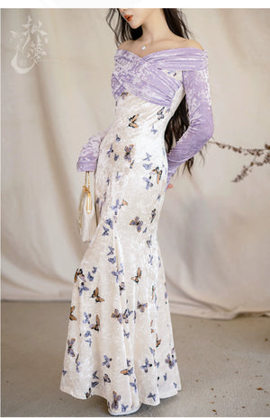 Side view of a butterfly-printed velvet fishtail skirt paired with a purple off-shoulder top, showcasing elegant design.