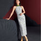 Long sleeveless cheongsam dress with a green floral jacquard pattern, high slit, and fitted silhouette. Made from cotton, silk, and polyester.