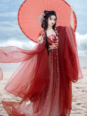 Step into the opulent world of Tang Dynasty elegance with our exquisite Red Hanfu Ensemble. Featuring a chest-length wrap skirt adorned with intricate super fairy embroidery and paired with a flowing large-sleeved top suit, our ensemble captures the essence of Tang Dynasty grandeur and sophistication. Embrace the rich heritage and timeless beauty of ancient Chinese fashion with our stunning collection.