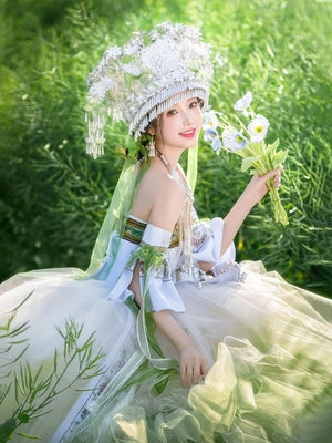Green version of Pink Miao Clothing Women's Summer Cake Dress with floral headpiece and layered skirt, styled for outdoor cultural events.