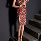 Full-length view of red cheongsam with crane print and chic split skirt.