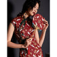 Close-up of red cheongsam with crane print and intricate button details.