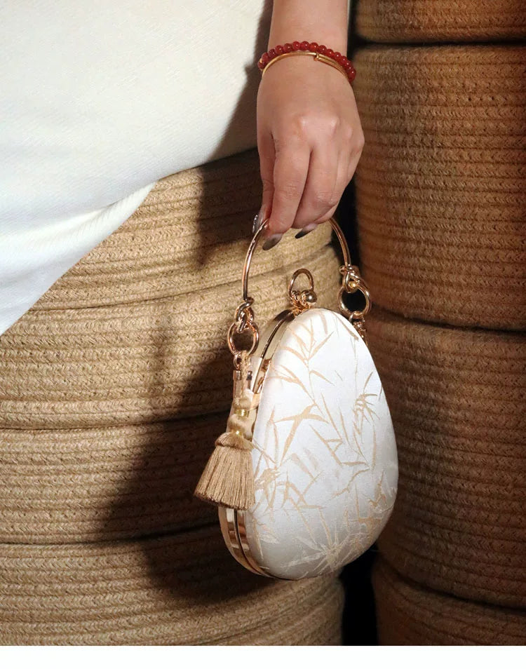 Angled view showing the metal frame and rounded bag body