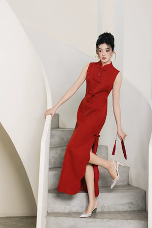 Side pose showing slit and bow detail on vermilion red bridal cheongsam