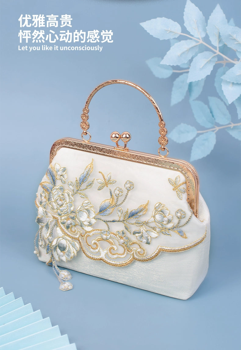 Yuejian Hanfu bag in white with gold floral embroidery and vintage handle, styled with a soft blue background for a refined look.