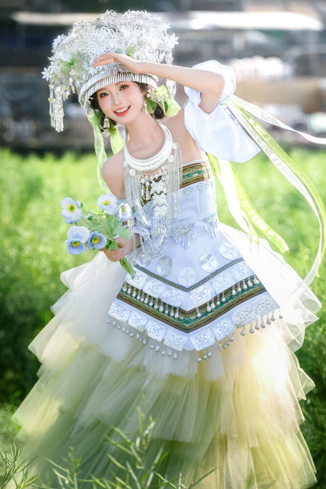 Green version of Pink Miao Clothing Women's Summer Cake Green Dress with floral bouquet and silver headpiece in a grassy field.