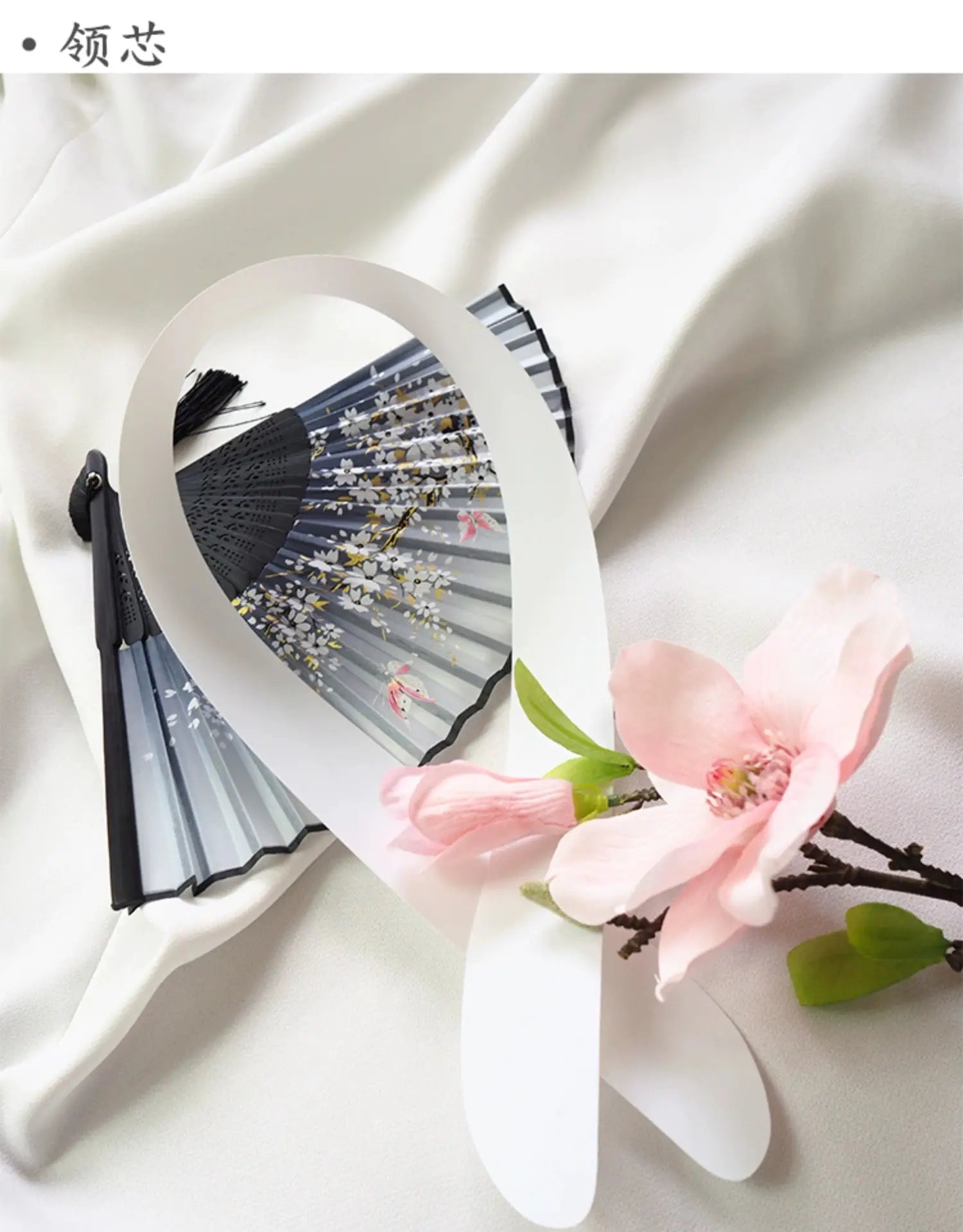 Close-up of a floral fan and pink blossom accessory, complementing the white and blue Yukata Kimono Dress for a traditional Japanese look.