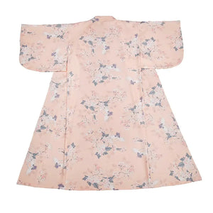 Flat lay of a pink yukata kimono with crane and floral patterns, highlighting its elegant and traditional Japanese design.