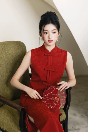 Seated front view of vermilion red bow bridal cheongsam