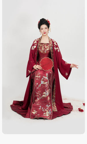 Seated model in [Dan Que Acacia] New Chinese Style Red Wedding Dress showing full embroidery and traditional silhouette.
