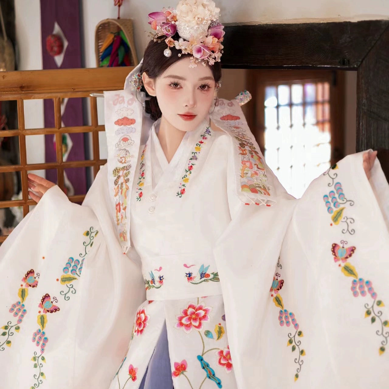 Traditional Korean bridal hanbok with intricate embroidery and floral details.