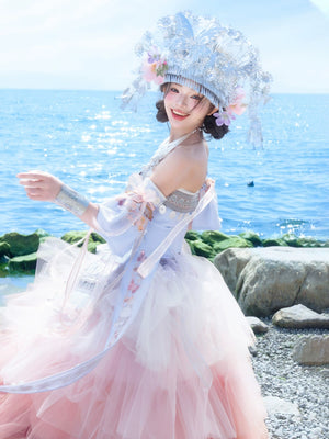 Twirl-ready Pink Miao Clothing Women's Summer Cake Green Dress with layered pink tulle and traditional silver headwear by the sea.