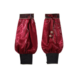 Pair of red detached sleeves with black cuffs