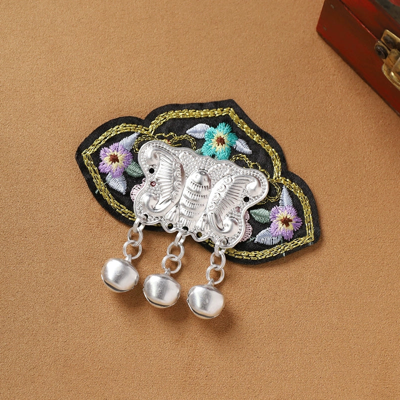 Black floral Guizhou Miao fridge magnet with silver butterfly and bell fringe, handmade ethnic refrigerator decoration.