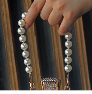 Faux-pearl handle and chain attachment detail