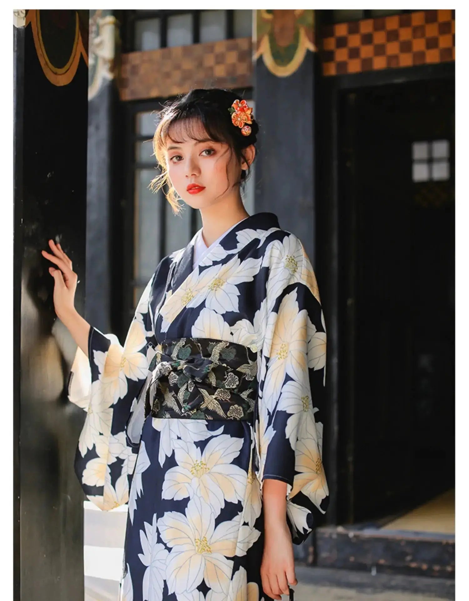 Elegant Japanese kimono dress for women featuring a black and white floral design, styled for festivals with a traditional obi belt.