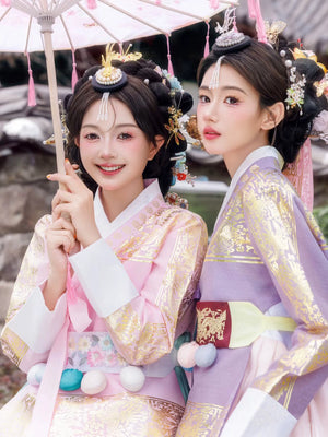 Pink and purple Hanbok with gold details, complemented by traditional Korean hairstyles and accessories.