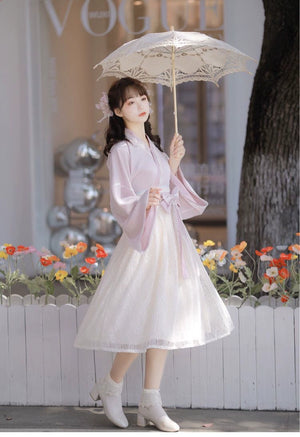 Pink Modern Hanfu Women's Chinese Style Dress with lace skirt and ribbon belt, styled with parasol for a graceful spring look.