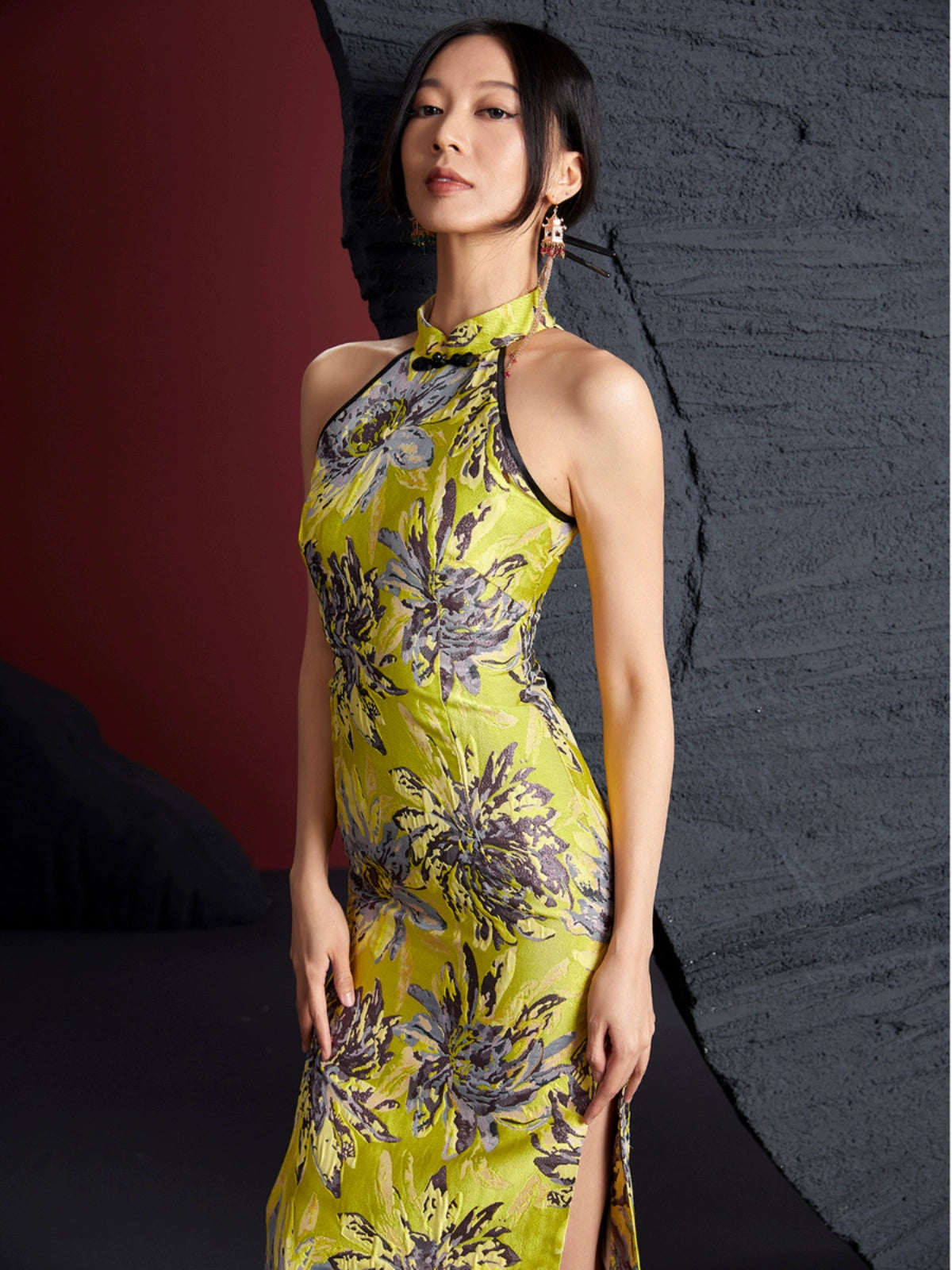 Gold bamboo cheongsam in jacquard brocade with floral patterns, sleeveless halter neck design, and side slit. Elegant non-stretch fabric.