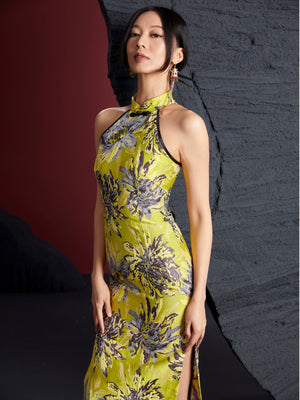 Gold bamboo cheongsam in jacquard brocade with floral patterns, sleeveless halter neck design, and side slit. Elegant non-stretch fabric.