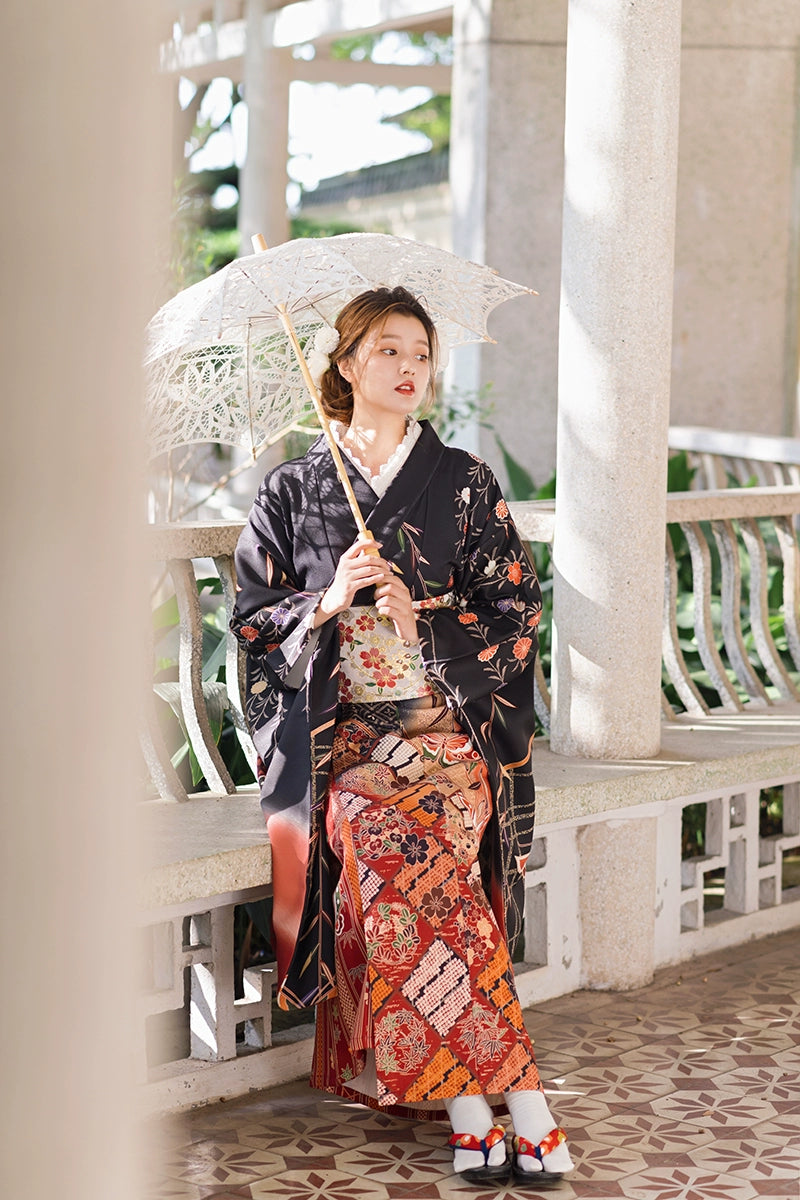 Model in a black butterfly kimono with a parasol, blending elegance and tradition.