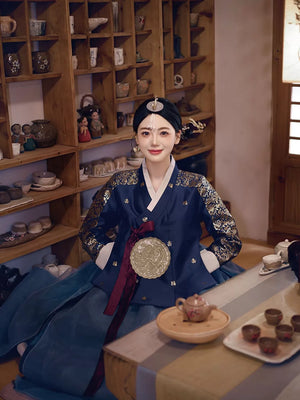 Korean woman in a navy blue bronzing hanbok court dress sitting in a traditional tea room, exuding cultural sophistication and charm.