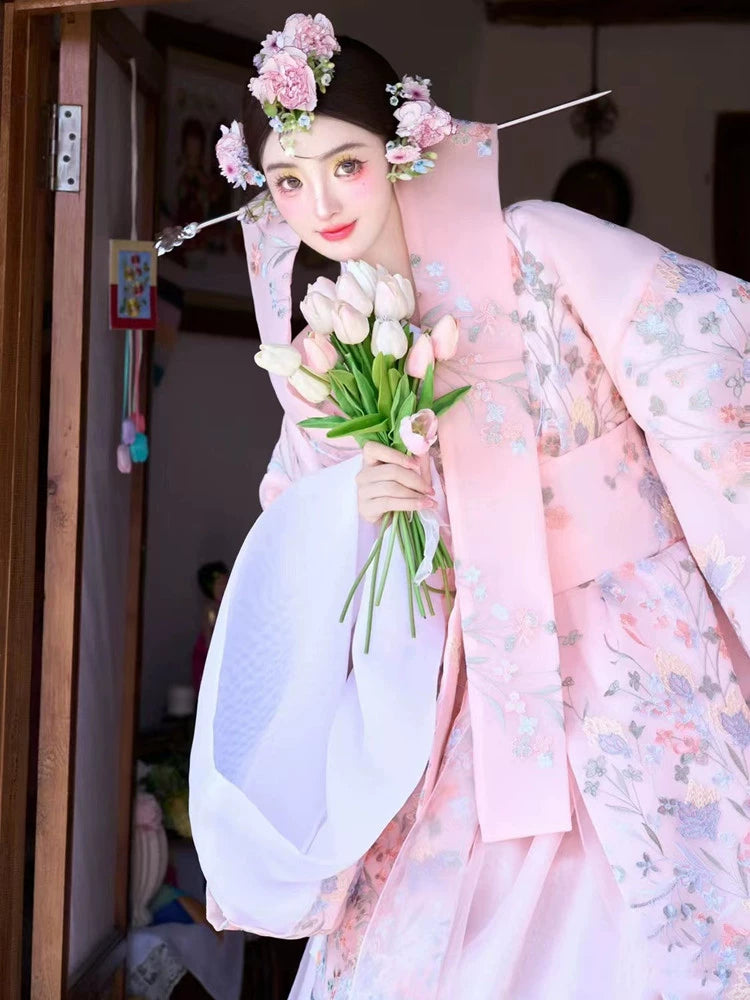 Pink Korean court dress with floral embroidery, accessorized with tulips.