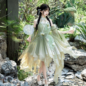 Model in garden wearing Chinese Lolita Dress Women's Summer with butterfly embroidery and layered skirt for an ethereal look.