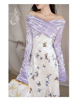 Close-up of a purple velvet off-shoulder top paired with a butterfly-printed fishtail skirt, highlighting intricate details.