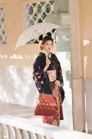 Full view of a black butterfly kimono with intricate Japanese patterns.