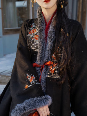 Close-up of black woolen Hanfu coat showcasing intricate floral embroidery and soft faux fur details for a traditional look.