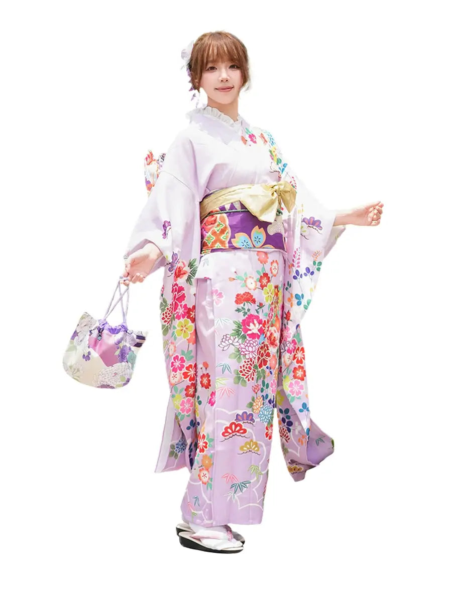 Full view of a Japanese kimono dress with big sleeves, floral patterns, and a purple obi, styled for formal and cultural occasions.