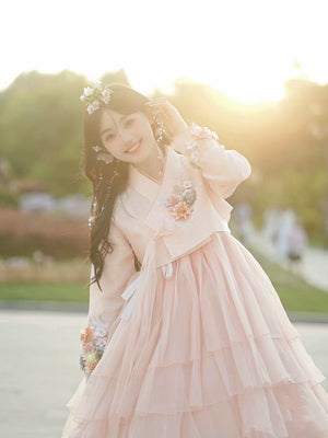 Graceful pink Yanji Korean dress with soft layers and floral embroidery, perfect for any event.