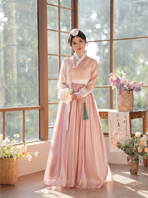 Elegant pink hanbok dress with lotus root hue, featuring a traditional Korean design. Perfect for cultural events and special occasions.