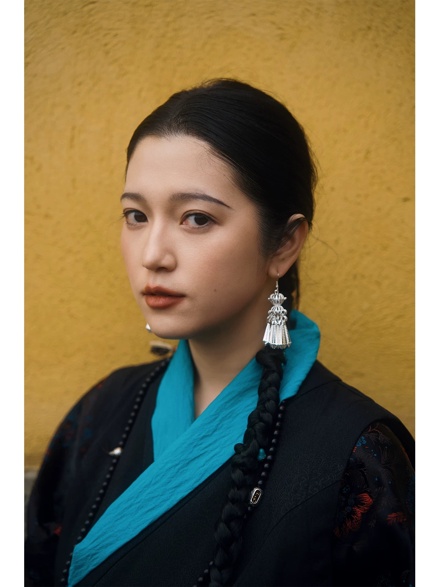 Snow black Xizang dress separates seated lifestyle photo with turquoise cuffs