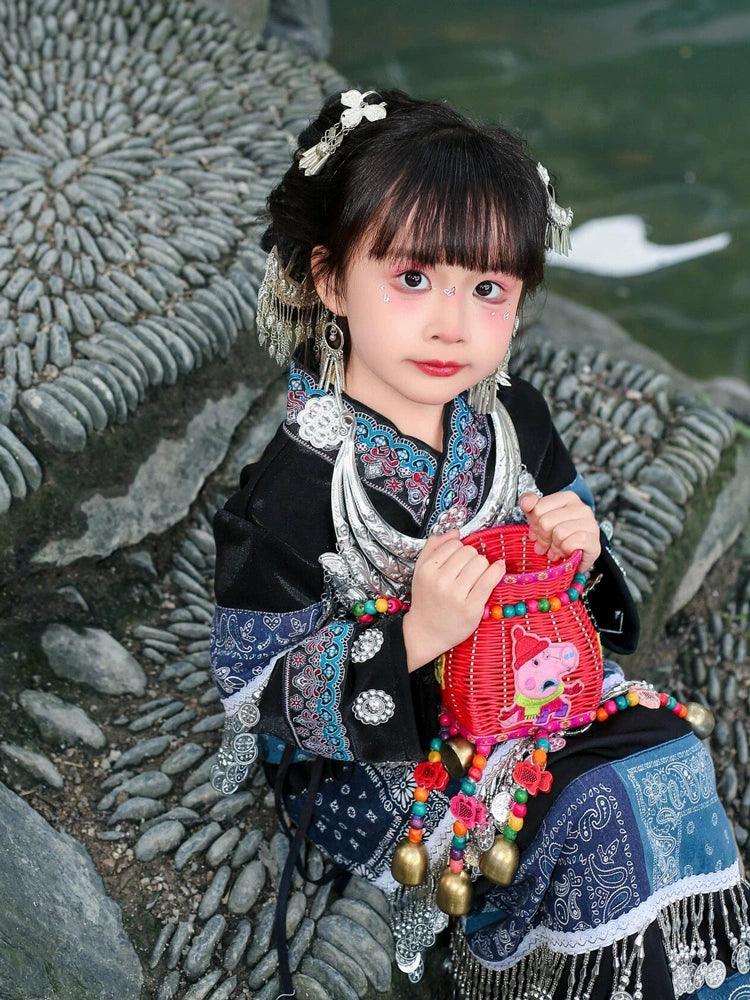 Authentic Miao blue Dai dance costume for girls with red pouch and silver jewelry, perfect for traditional Chinese dance events.