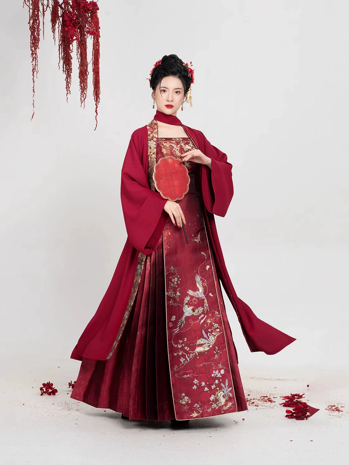 Graceful pose in [Dan Que Acacia] New Chinese Style Red Wedding Dress highlighting pleated skirt and embroidered phoenix motifs.
