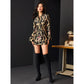 Full-length view of black and gold jacquard dress suit with thigh-high boots.