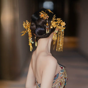Back view of Chinese antique bridal hairpin set with butterfly motifs and golden tassels, styled with a traditional updo.