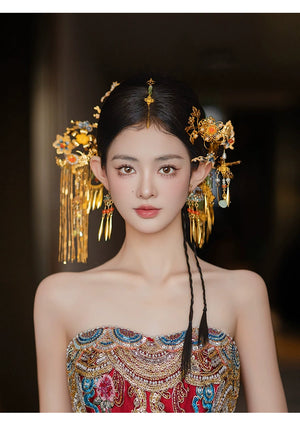 Front view of bride adorned with Chinese butterfly tassel hairpin, highlighting antique gold detailing and floral accents.