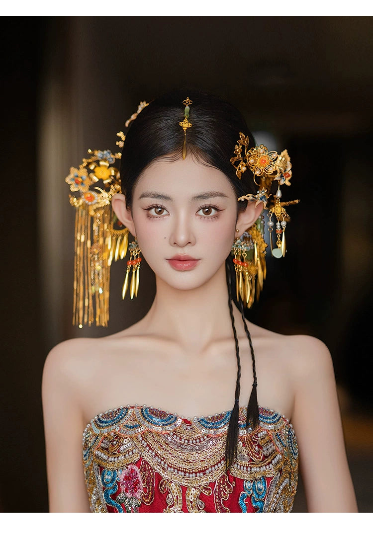 Front view of bride adorned with Chinese butterfly tassel hairpin, highlighting antique gold detailing and floral accents.