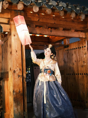 Princess-style Korean Hanbok with intricate details, featuring a blue skirt and gold jeogori, ideal for special occasions and cultural events.